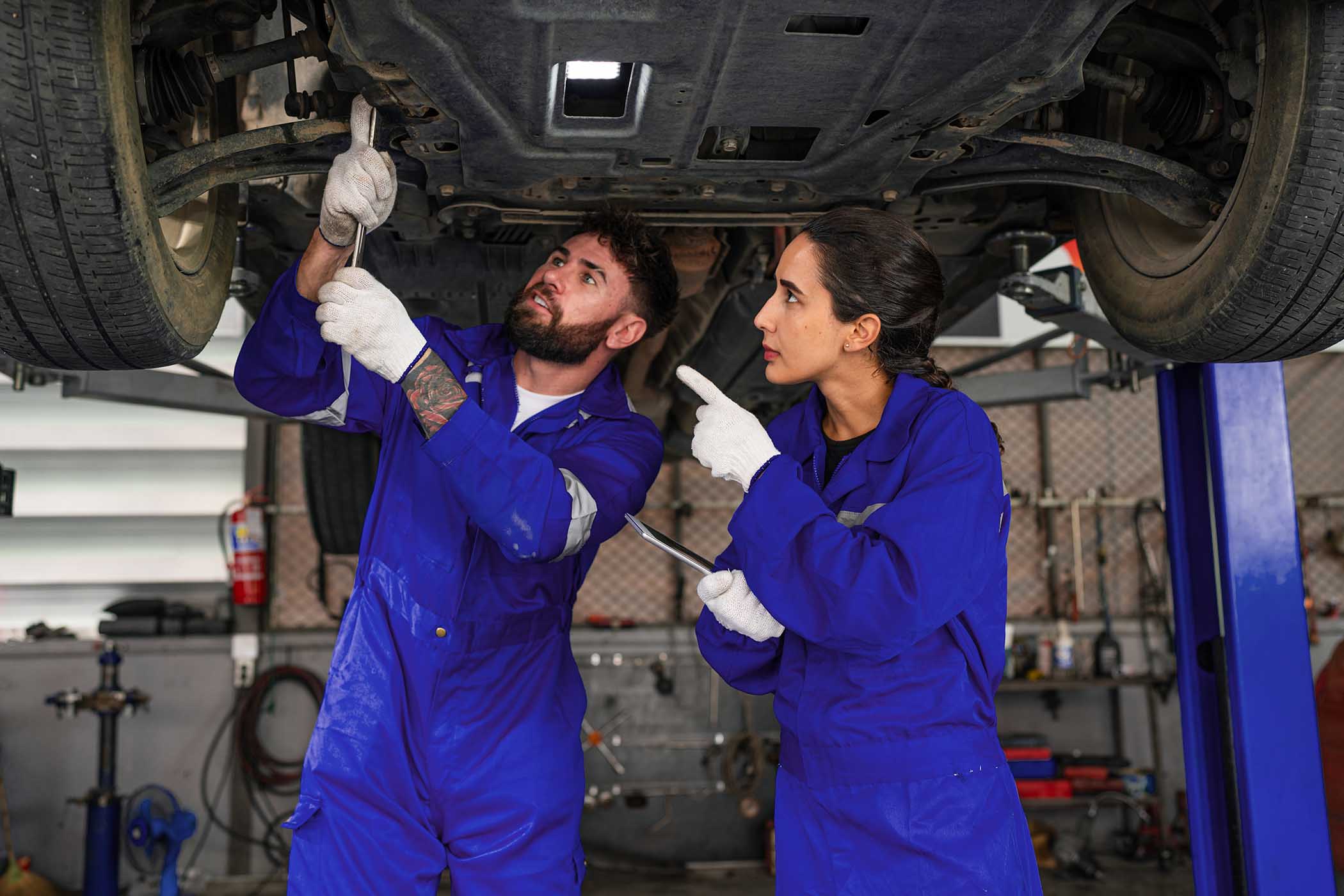 team-auto-mechanic-in-blue-uniform-are-repair-and-2YQ7UV6.jpg